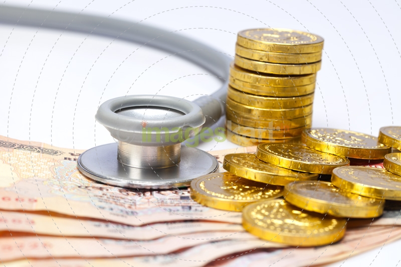 stethoscope with gold coins and cash