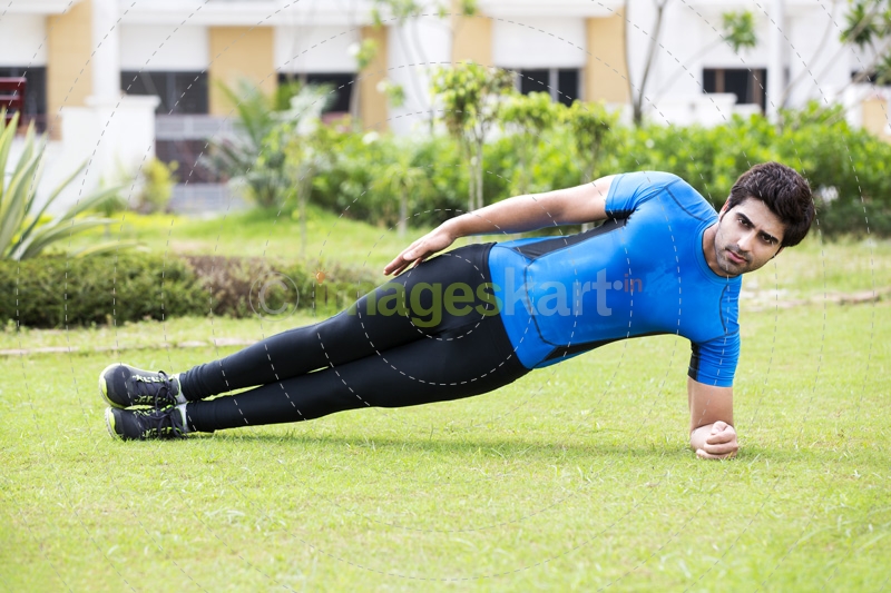 young boy exercising in park 