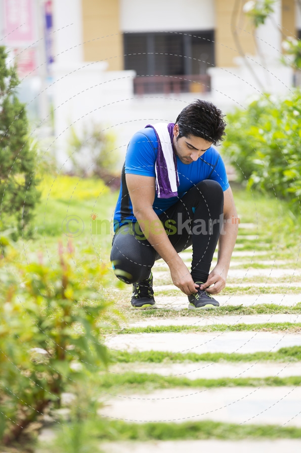 man tying his shoes laces 