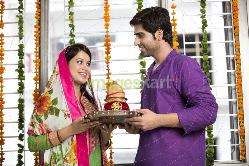 couple with pooja thali and kalash