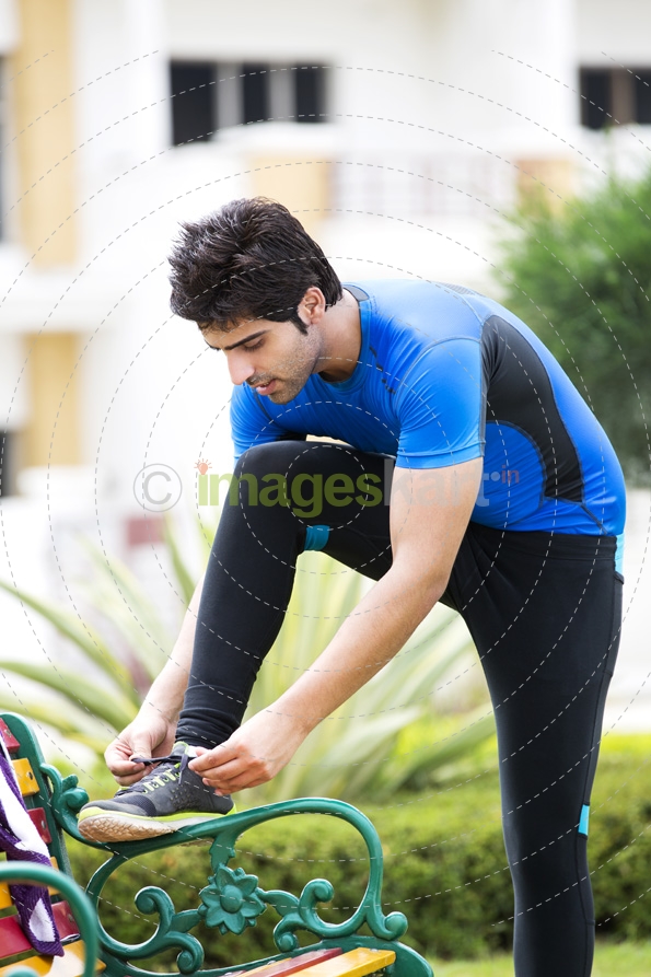 man tying his shoe laces 