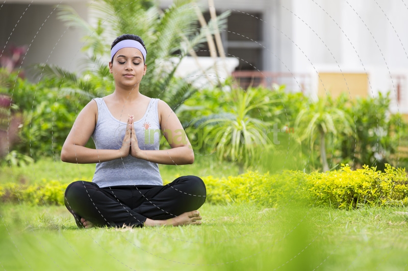 girl doing namaskara with eyes closed 