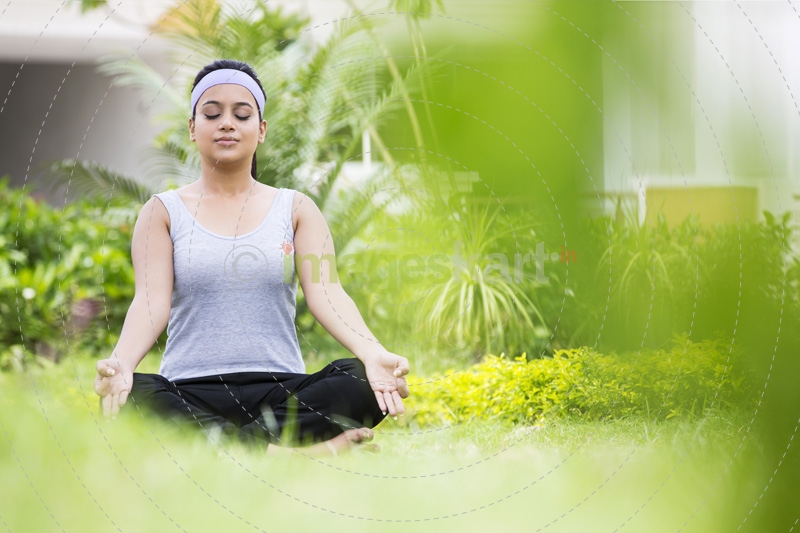 girl practicing yoga in park 
