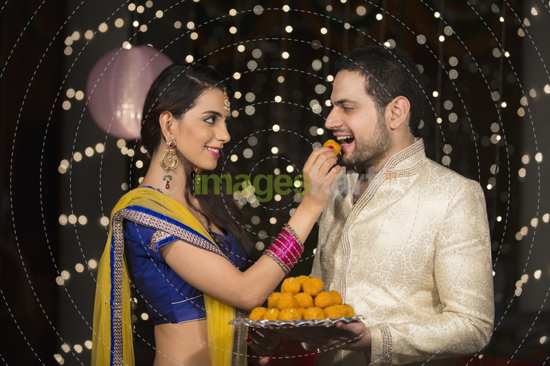 wife feeding sweets to husband