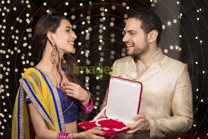 man gifting wife a necklace 