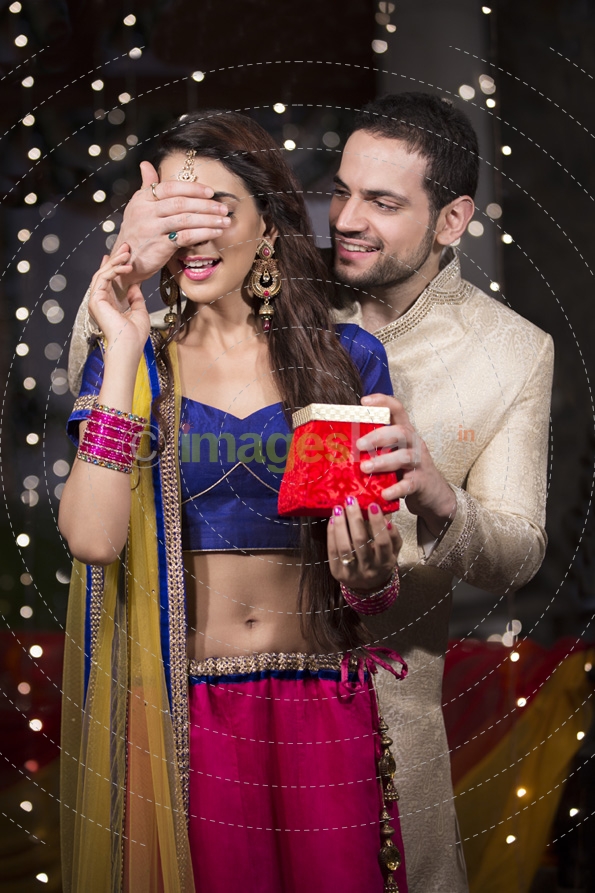 husband giving a surprise gift to his wife