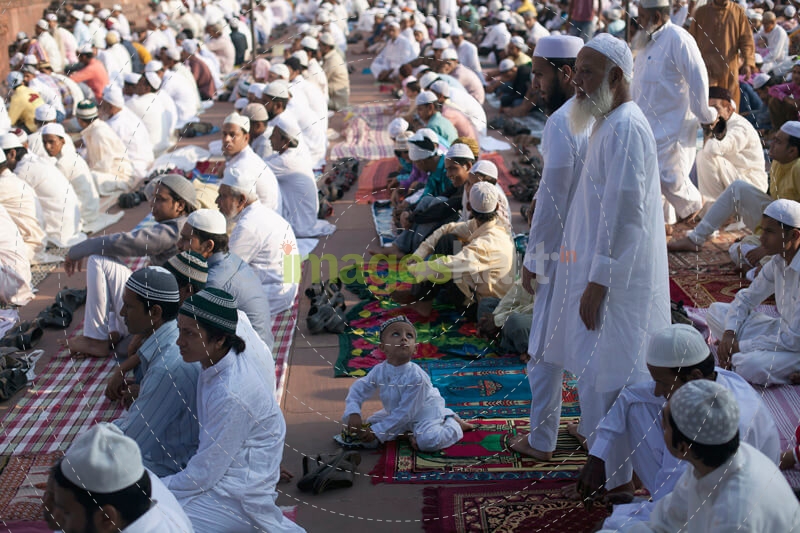 men attending eid prayer meeting at jama masjid 