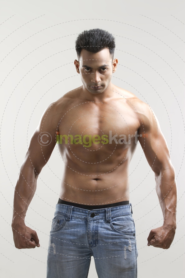 portrait of a muscular man in a blue denim