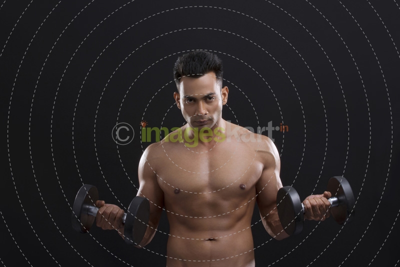 portrait of muscular man against a blue background