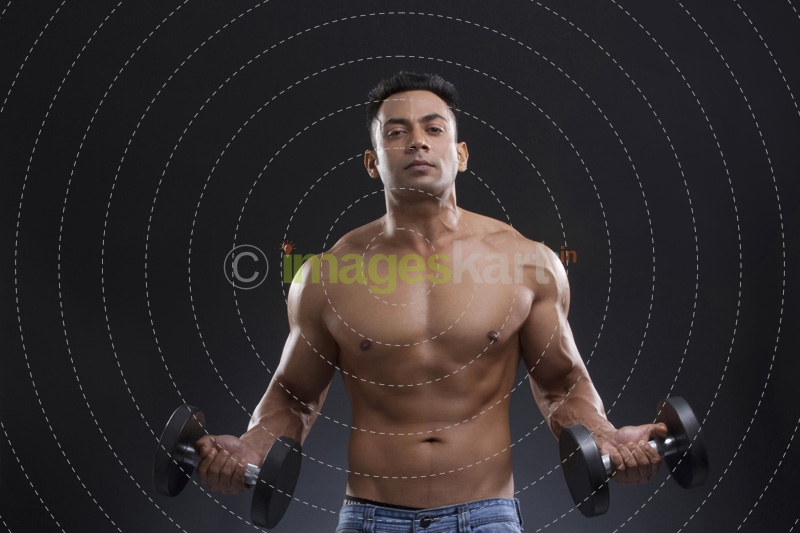portrait of muscular man against a blue background