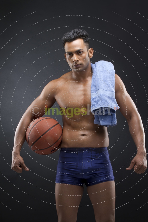 athletic man posing with basket ball