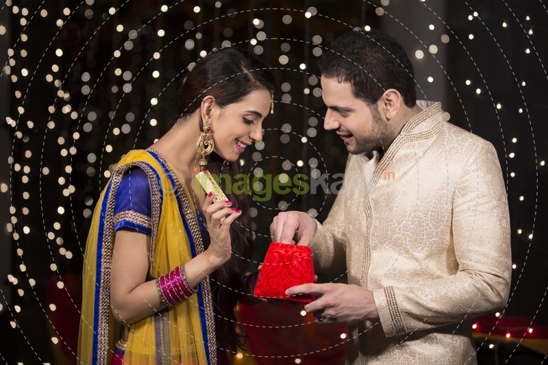 woman giving surprise gift to her husband 