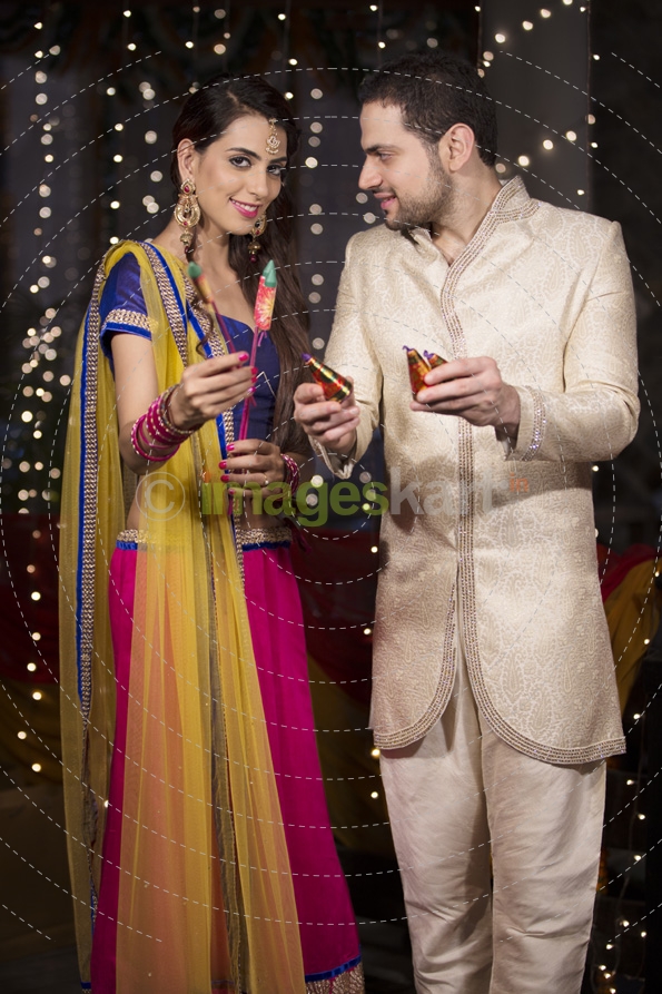 couple with crackers on diwali 