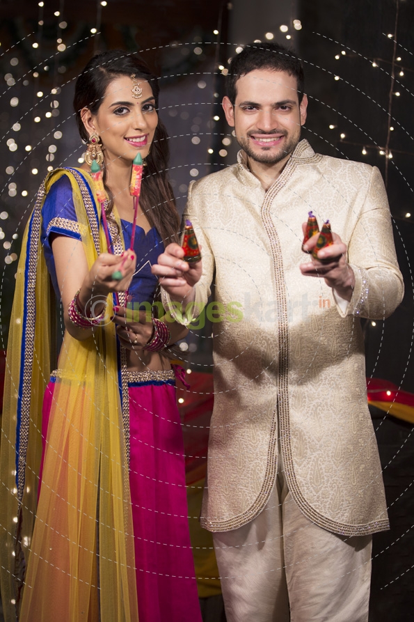 couple with crackers on diwali 