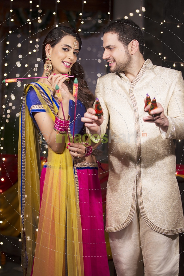 couple with crackers on diwali 