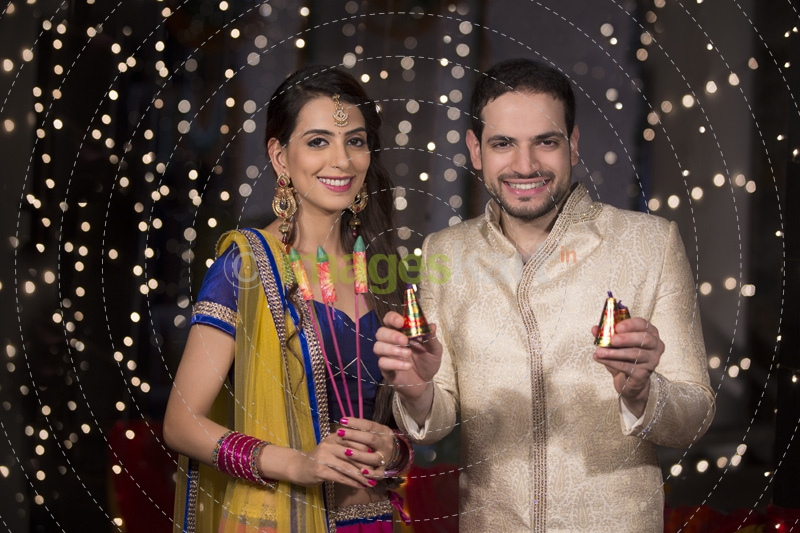 couple with crackers on diwali 