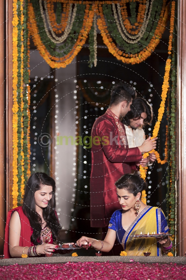 couples decorating home on diwali 
