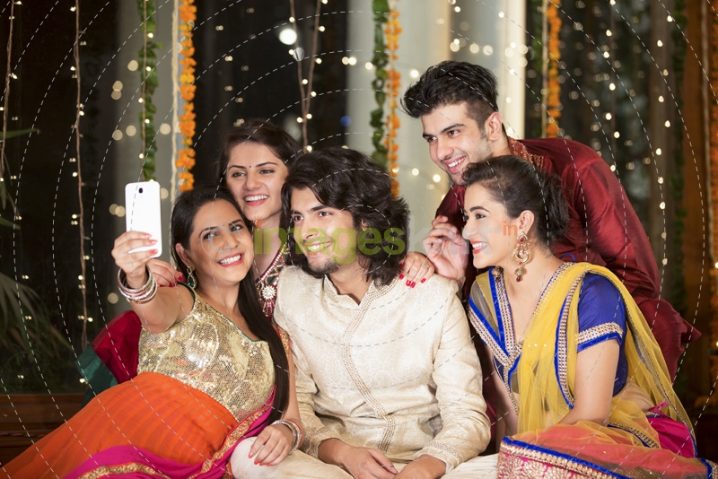 group of friends clicking photographs on a festival