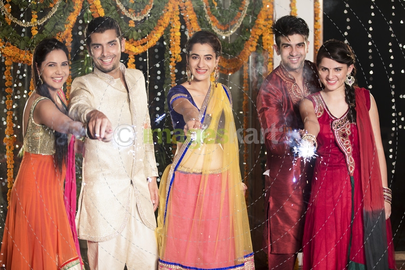 couple celebrating diwali with sparklers 
