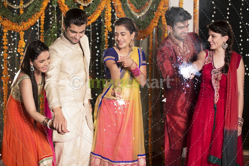 couple celebrating diwali with sparklers 