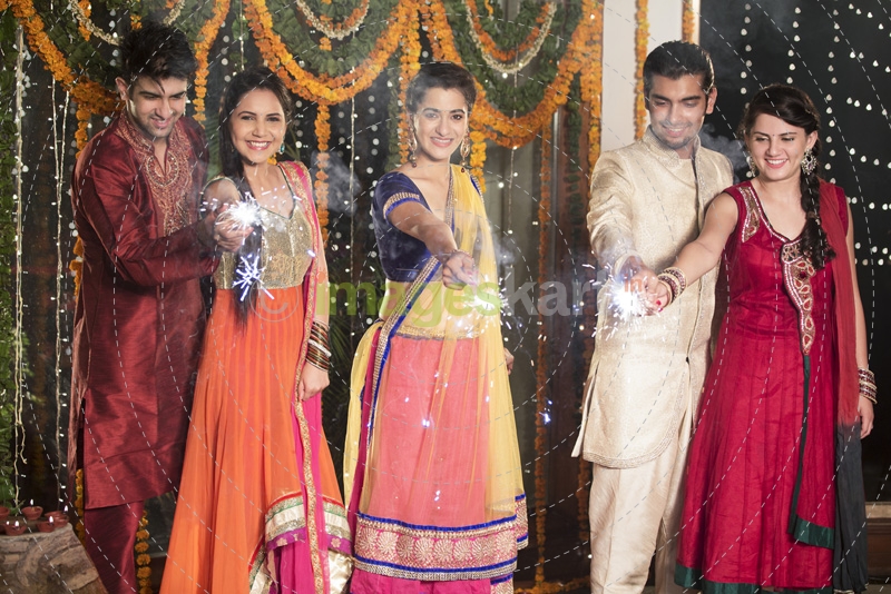 couple celebrating diwali with sparklers 