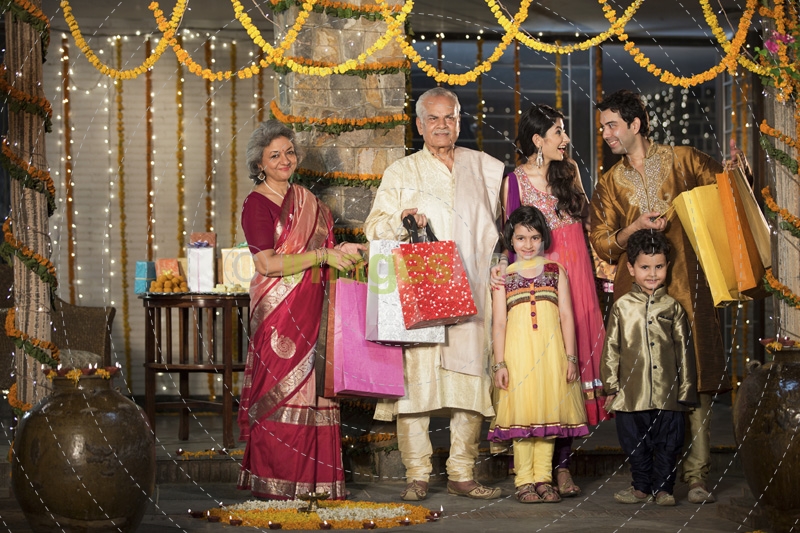 family with diwali gifts standing at entrance of house 
