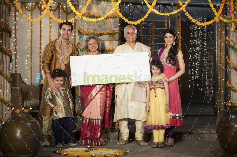 family standing at entrance with message board on diwali