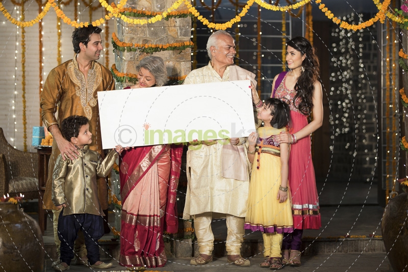 family standing at entrance with message board on diwali