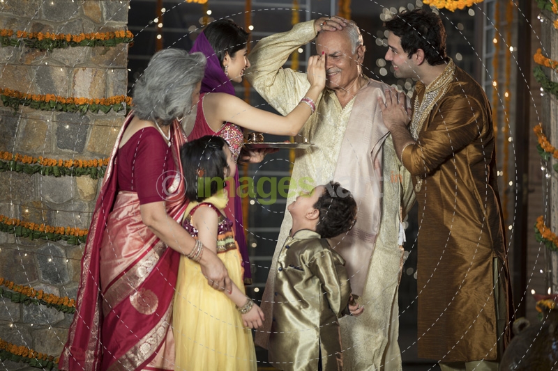 family doing diwali pooja 