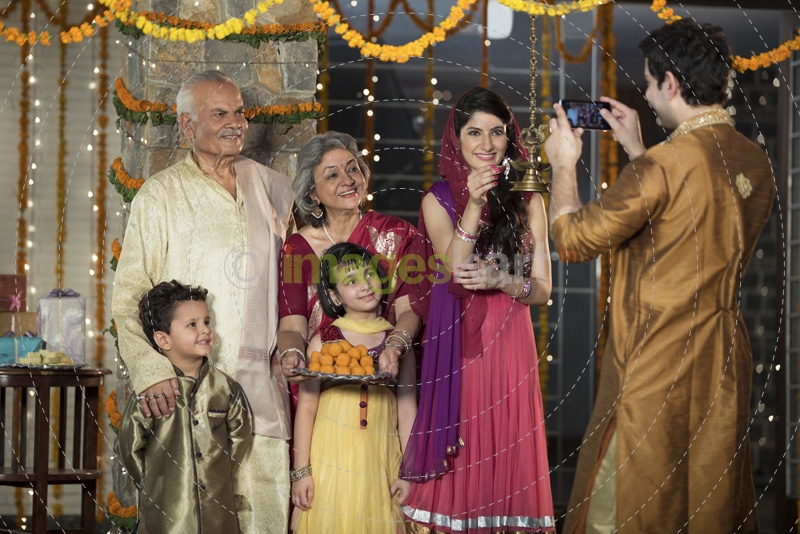 family clicking pictures on diwali 