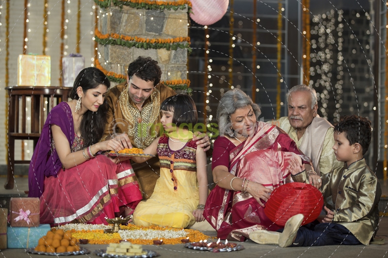 family celebrating diwali and doing pooja