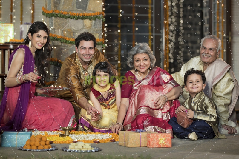 family celebrating diwali and doing pooja
