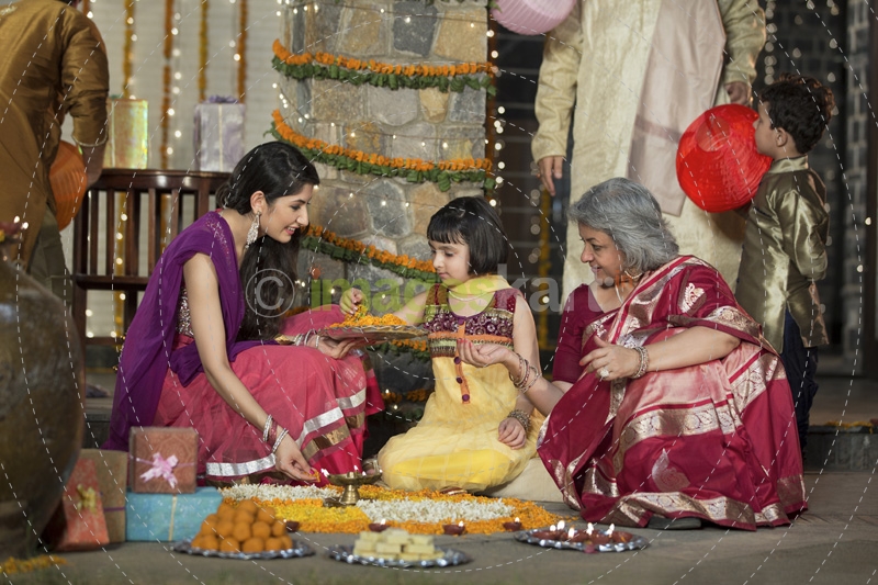 family celebrating diwali and doing pooja