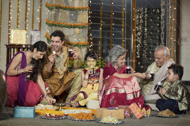 whole family sitting for diwali pooja
