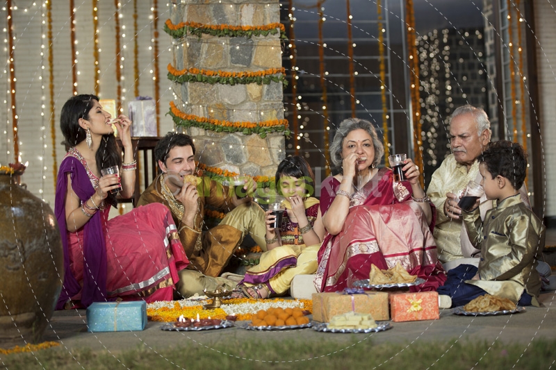 whole family sitting for diwali pooja