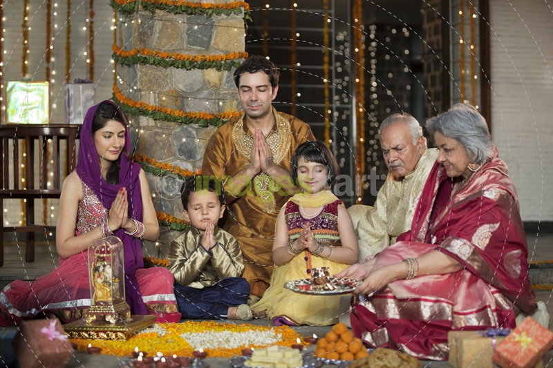 whole family sitting for diwali pooja