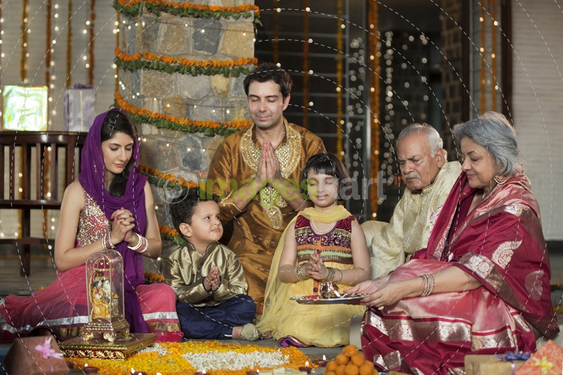 whole family sitting for diwali pooja