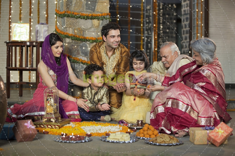whole family sitting for diwali pooja