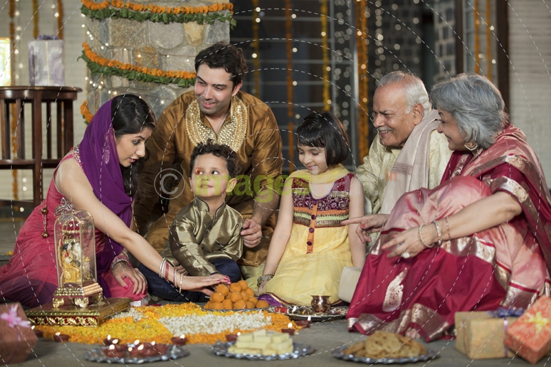 whole family sitting for diwali pooja