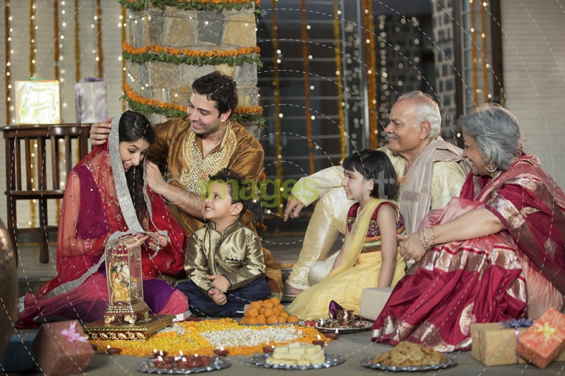whole family sitting for diwali pooja