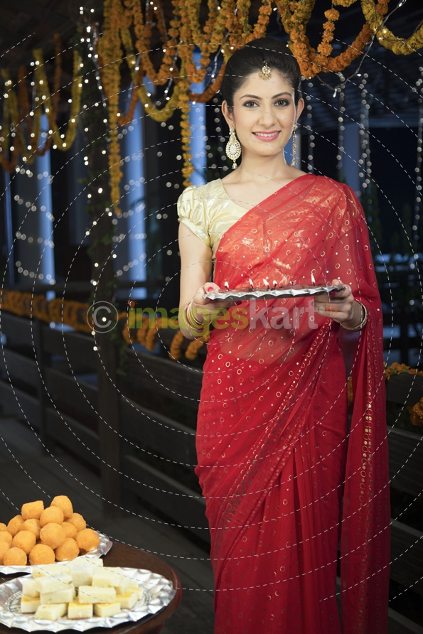 woman holding a pooja thali on diwali