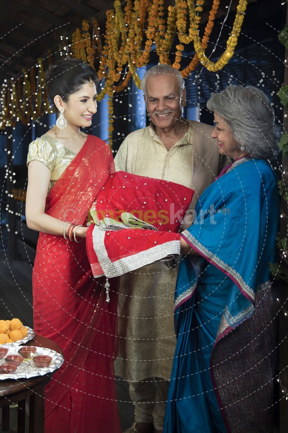 housewife with her in laws celebrating diwali
