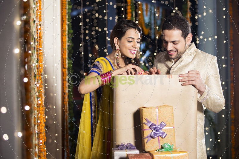 couple opening diwali presents 