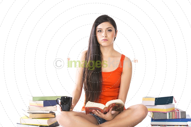 young female holding a coffee mug and a novel