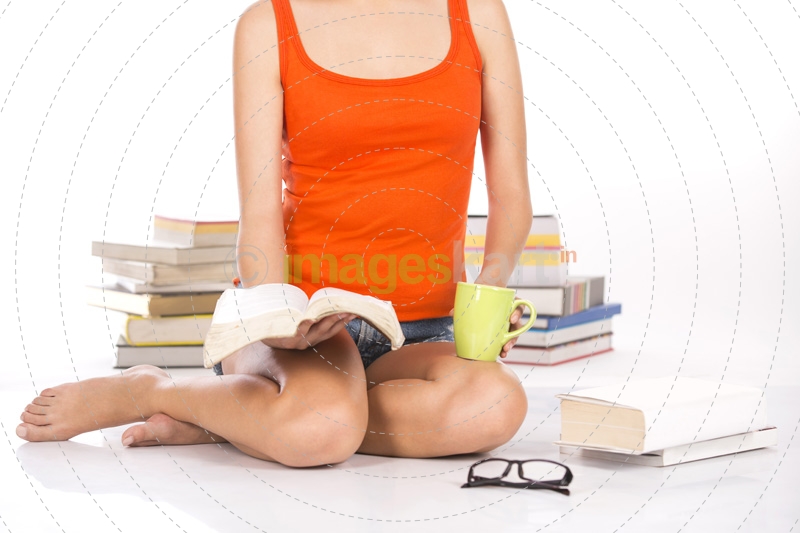 close up on a girl reading a book while having a coffee