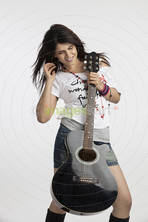 young beautiful woman with an acoustic guitar