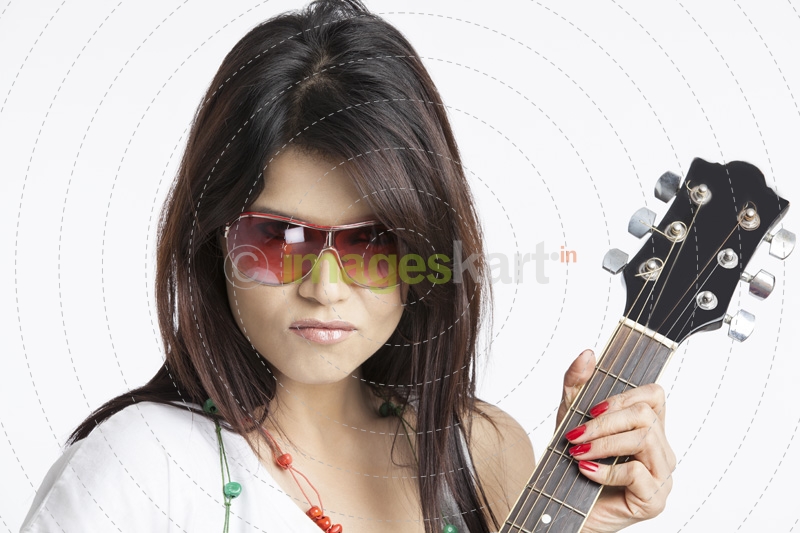 close-up of a girl playing guitar