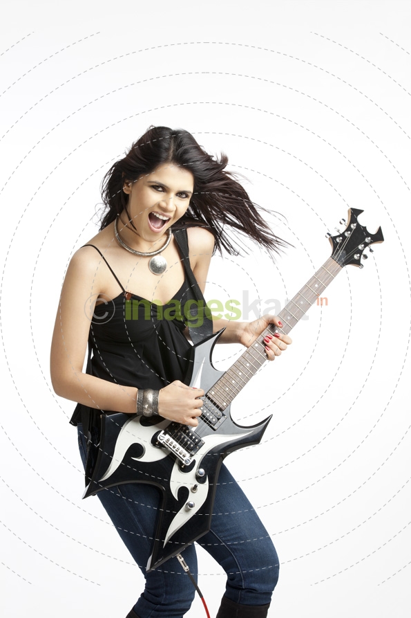 beautiful young female with electric guitar on white background