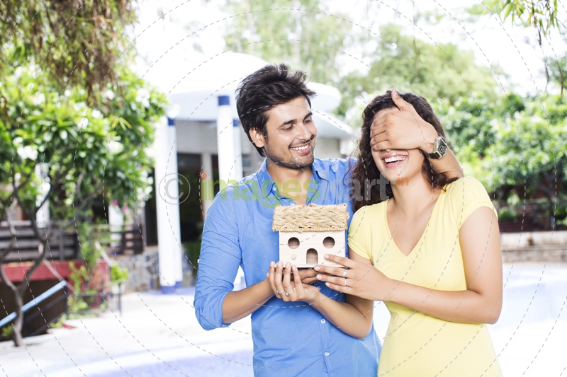 man surprising woman with new home