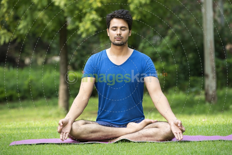 boy performing yoga in park during morning time